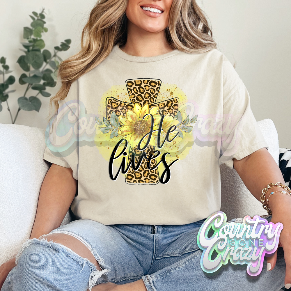 HE LIVES SUNFLOWERS AND LEOPARD CROSS - SAND T-SHIRT-Country Gone Crazy-Country Gone Crazy